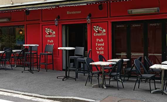 Red facade of the brasserie, tables and chairs